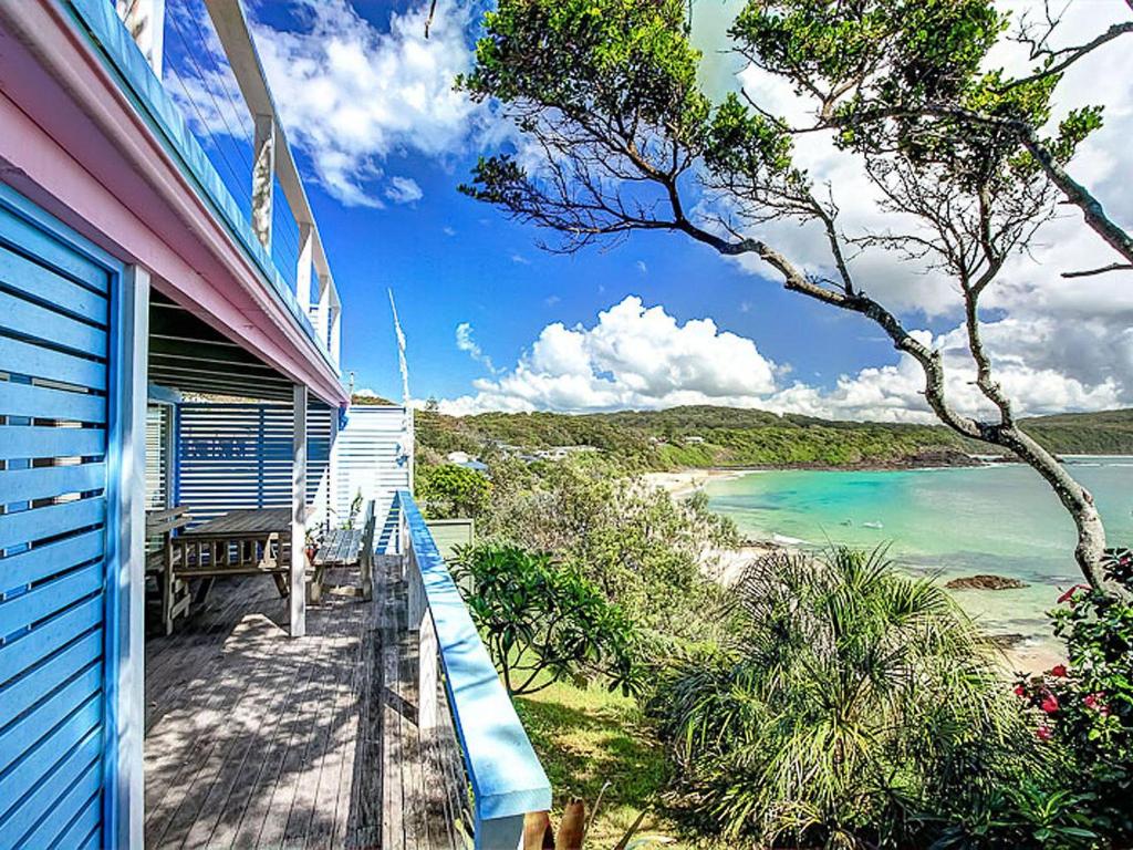 a balcony of a house with a view of the beach at The Shack in Seal Rocks