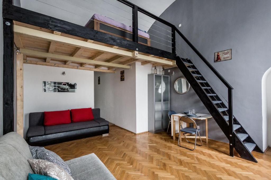 a living room with a loft bed and a couch at Mickey's Chain Bridge Apartments in Budapest