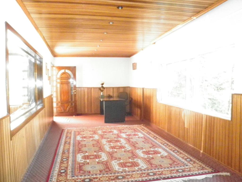 an empty hallway with a rug on the floor at CentreToni Arida in Al Arz