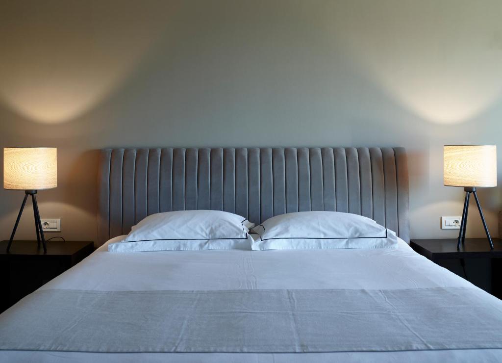 A bed or beds in a room at Pelagos Suites Hotel & Spa
