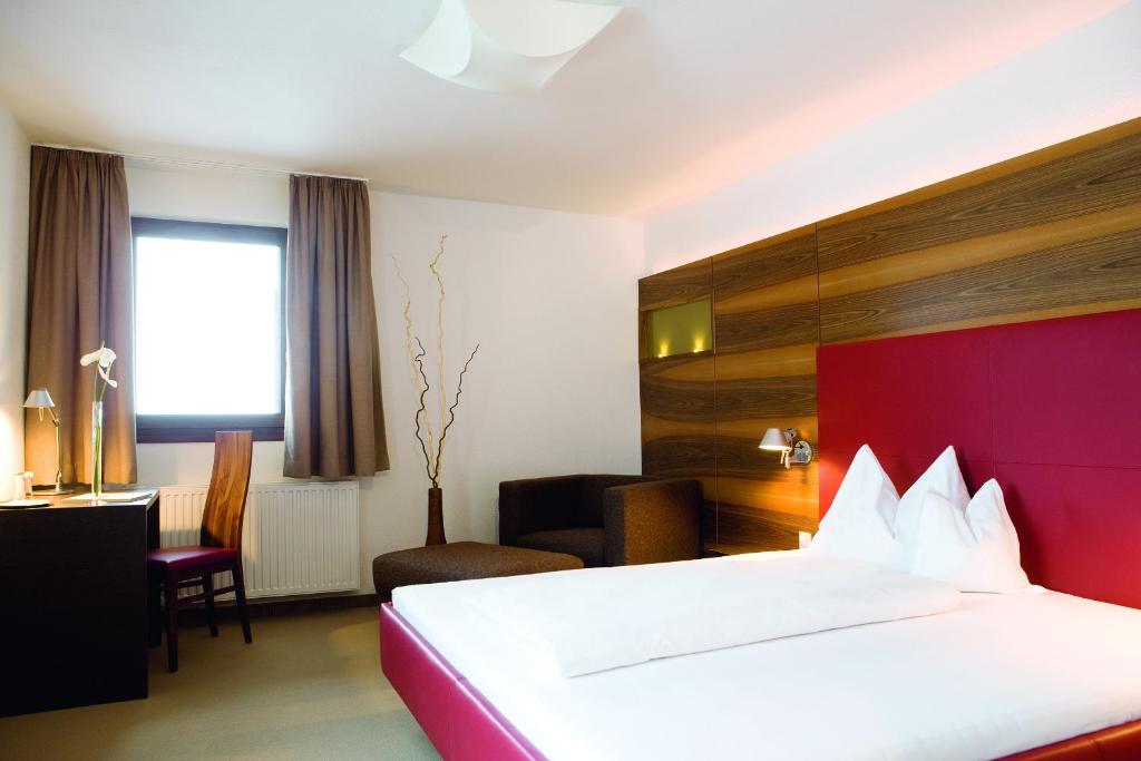 Postel nebo postele na pokoji v ubytování Hotel Angerer Alm