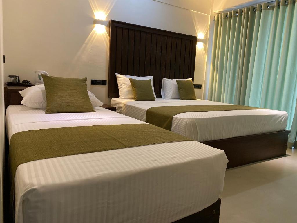 Postel nebo postele na pokoji v ubytování Royal Rock Sigiriya