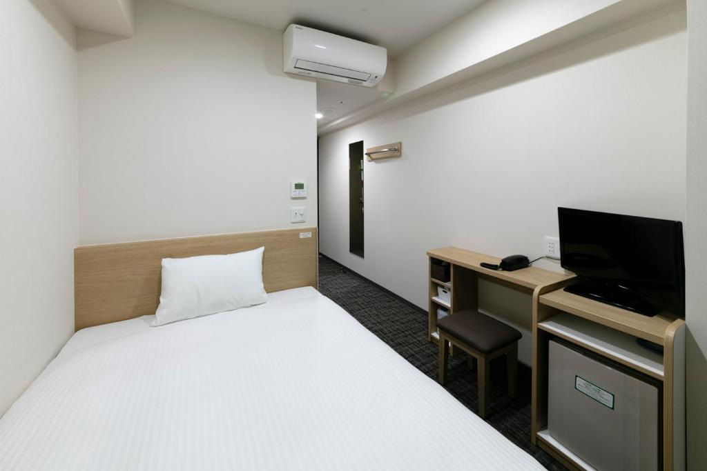 Postel nebo postele na pokoji v ubytování R&B Hotel Kyoto Shijo Kawaramachi