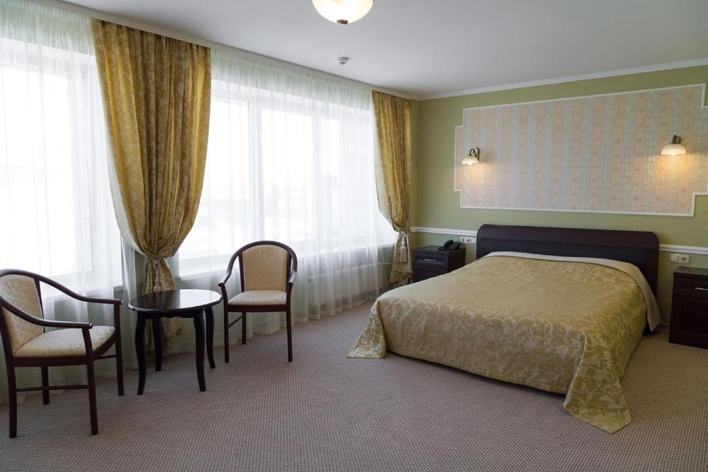 A bed or beds in a room at Otel Pervouralsk