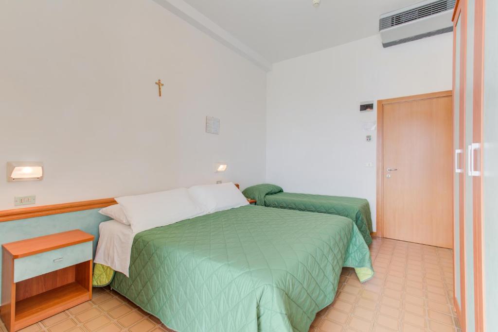 Postel nebo postele na pokoji v ubytování Hotel Astoria