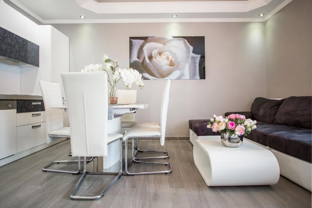 a living room with a table and a couch at Apartments Villa Paradise in Kaštela