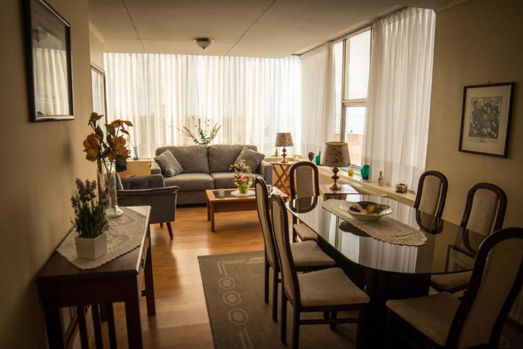 a living room with a table and chairs and a couch at Departamentos Los Ganaderos in Punta Arenas