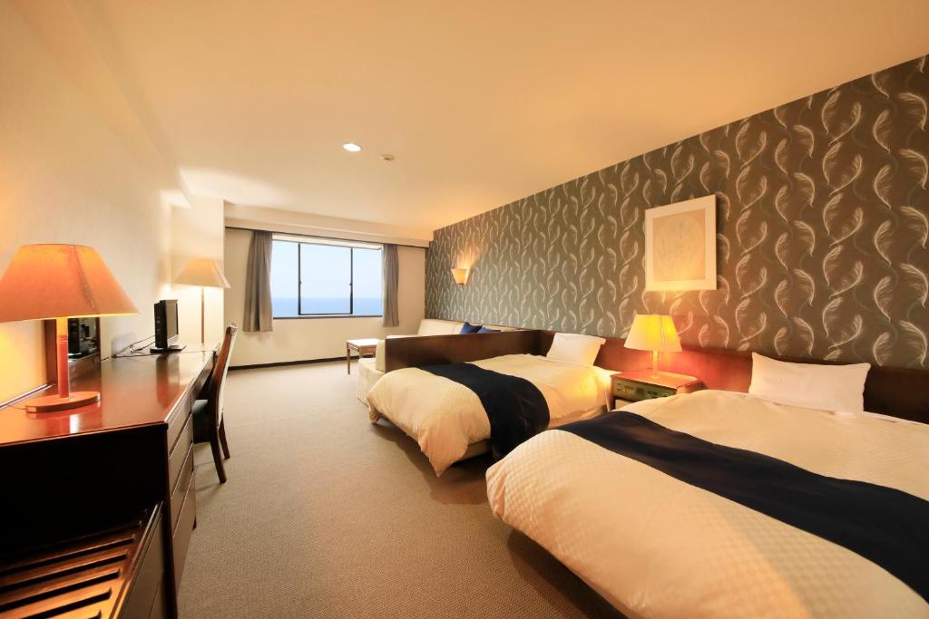 Postel nebo postele na pokoji v ubytování Oarai Park Hotel