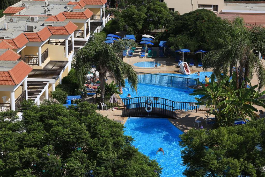 a beach with a pool and a pool table at Jacaranda Hotel Apartments in Protaras