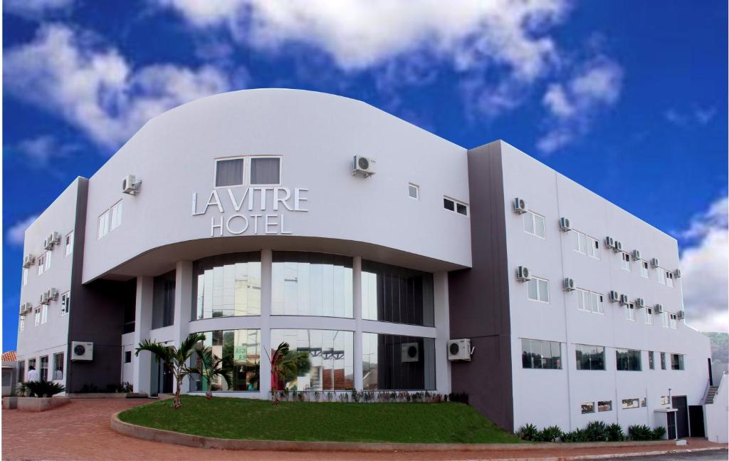 a large white building with a sign on it at La Vitre Hotel in Jataí