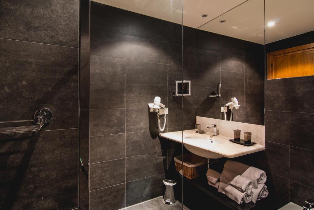 a bathroom with a sink and a shower at Hotel Aquadulci in Chia