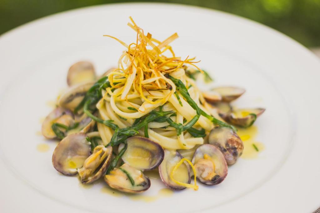 a plate of food with mushrooms and vegetables on it at Hotel Aquadulci in Chia
