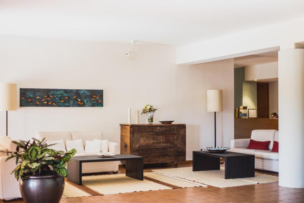 a living room with a couch and a table at Hotel Aquadulci in Chia