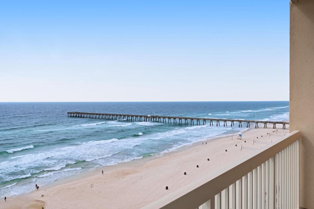 a view of a beach with a pier and the ocean at Calypso Resort in Panama City Beach
