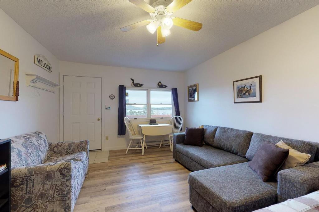 a living room with a couch and a table at Loon Nest in Rockwood