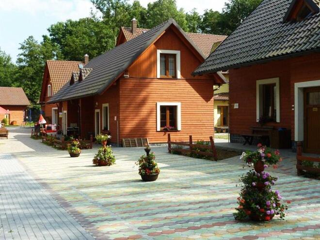 a house with potted plants in front of it at Chaty ve Ski-relax Avalanche Dolní Moravice in Dolní Moravice