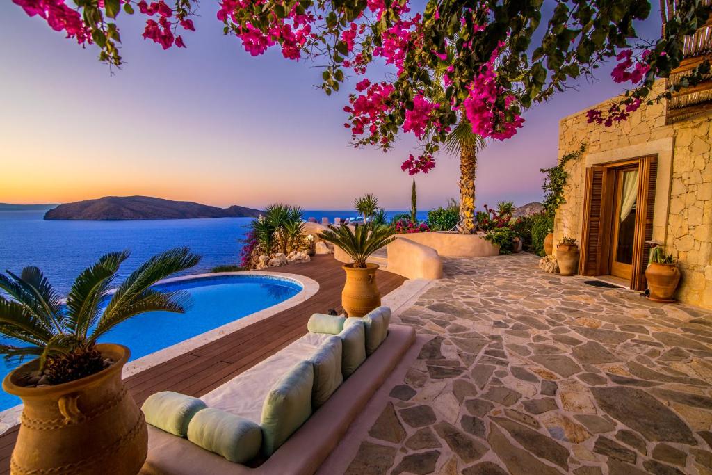 a villa with a pool and a view of the ocean at East Crete Villa Mirabello in Kavoúsion