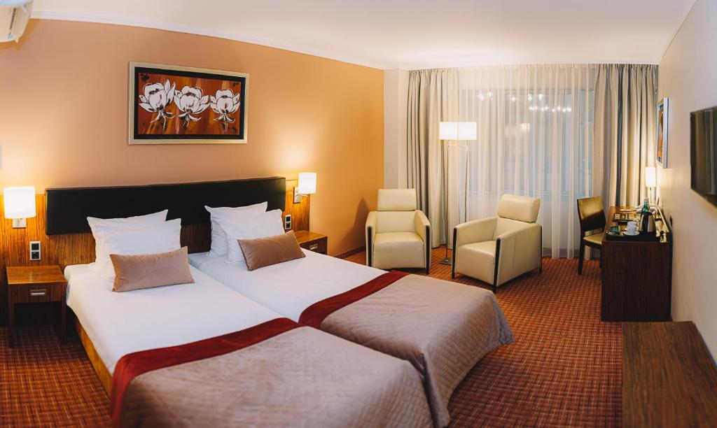 Postel nebo postele na pokoji v ubytování Avalon Hotel & Conferences