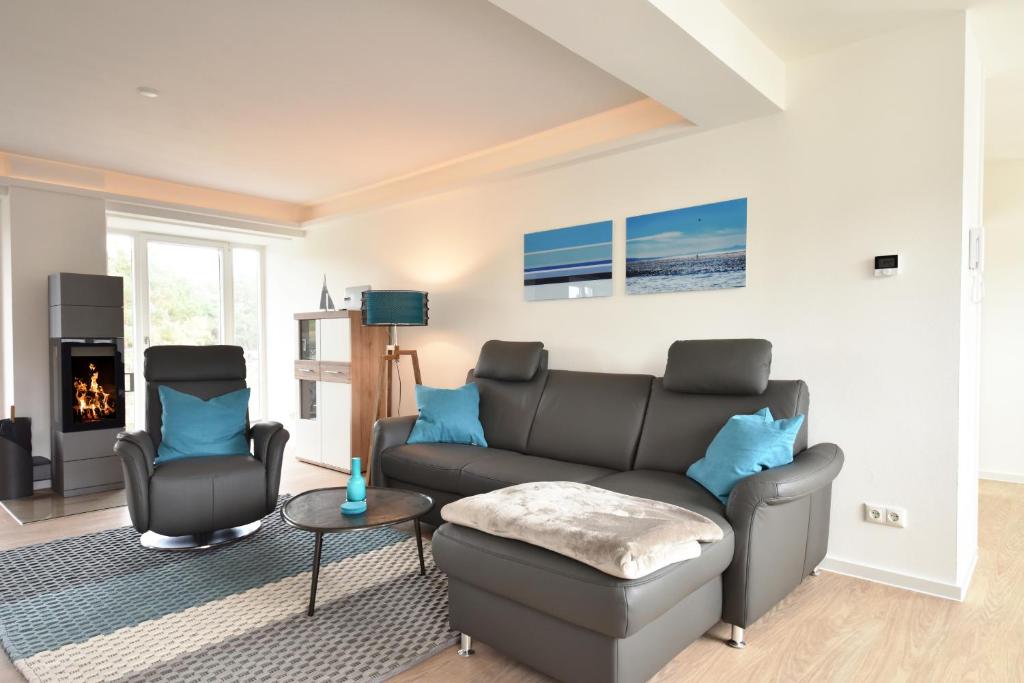 a living room with a couch and a chair at Ferienwohnung Aquamarin im Haus Arkona in Binz