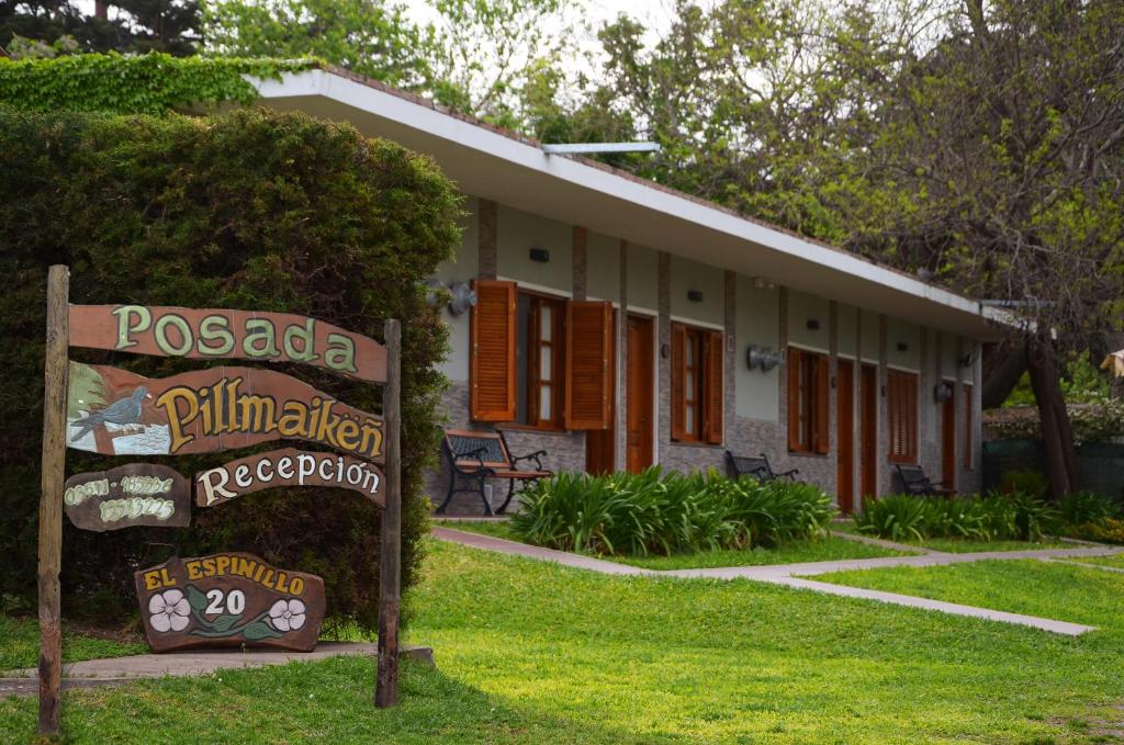 a building with a sign in front of it at apart-posada pillmaiken in Embalse