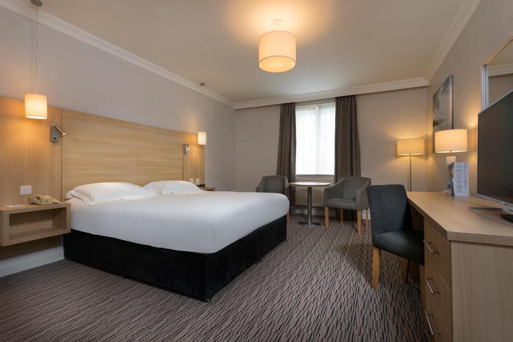 a hotel room with a bed and a desk at Park Inn by Radisson Shannon Airport in Shannon