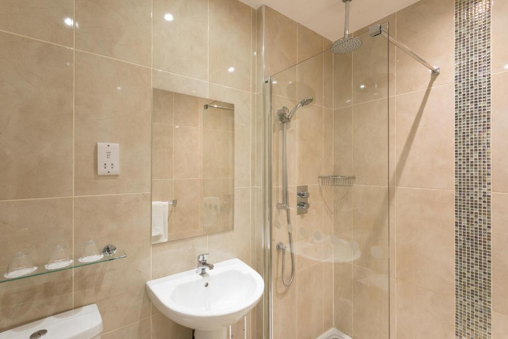 a bathroom with a shower and a sink and a toilet at Park Inn by Radisson Shannon Airport in Shannon