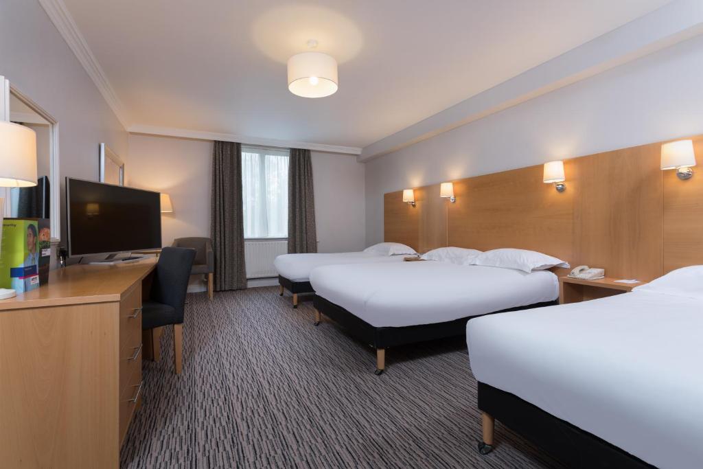 a hotel room with two beds and a flat screen tv at Park Inn by Radisson Shannon Airport in Shannon