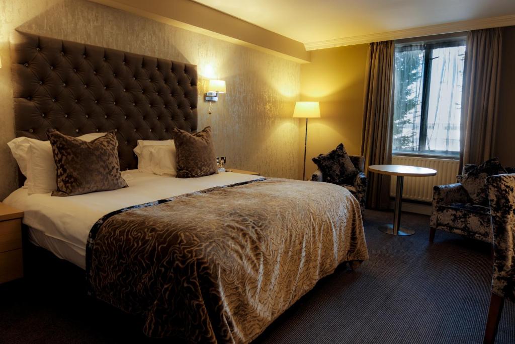 a hotel room with a large bed and a window at Park Inn by Radisson Shannon Airport in Shannon