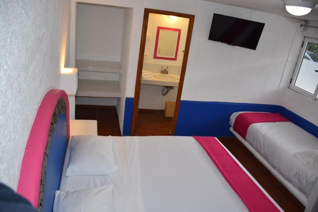 Postel nebo postele na pokoji v ubytování Hotel Pachuca Inn