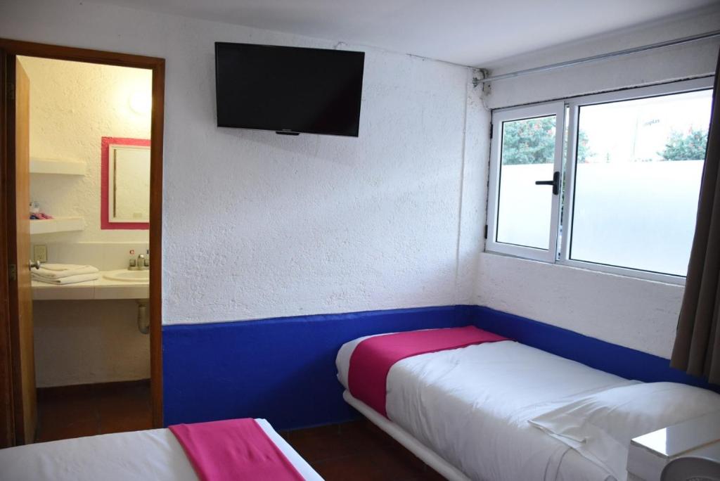 Postel nebo postele na pokoji v ubytování Hotel Pachuca Inn