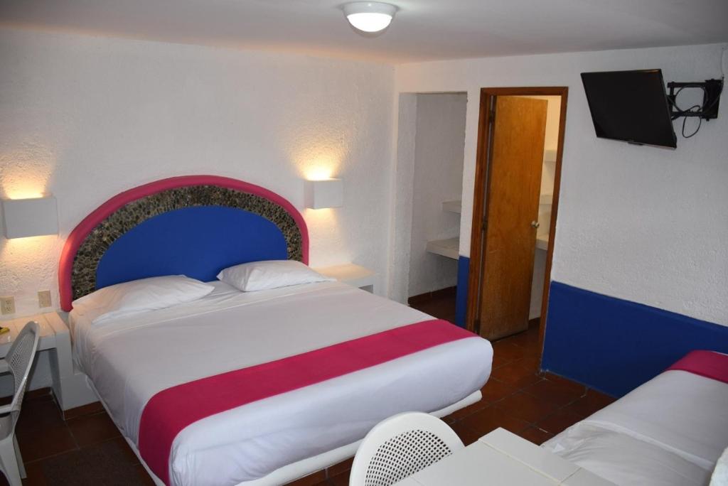 Postel nebo postele na pokoji v ubytování Hotel Pachuca Inn