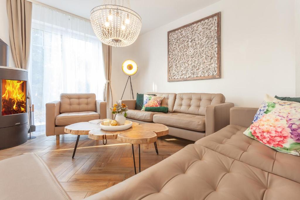 a living room with a couch and a table at Kapitänshaus Sellin mit Sauna und Kamin in Ostseebad Sellin