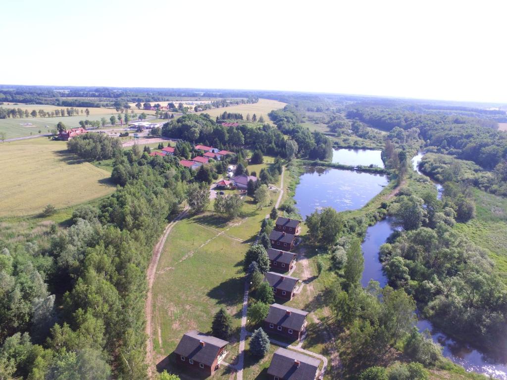 an aerial view of a village next to a river at Petrico Camp Resort in Krzywopłoty