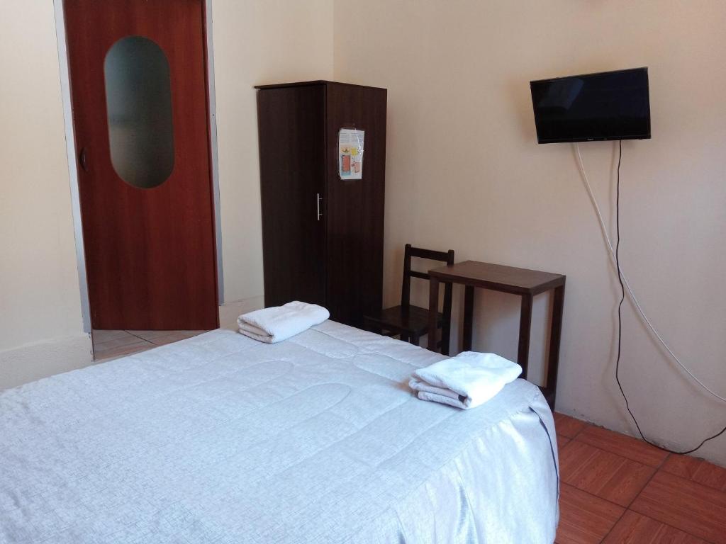 Postel nebo postele na pokoji v ubytování Mango Hostel B&B