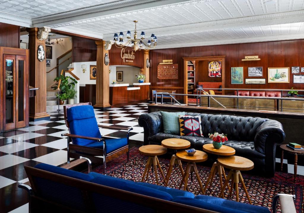 a lobby with a couch and chairs and tables at Graduate New Haven in New Haven