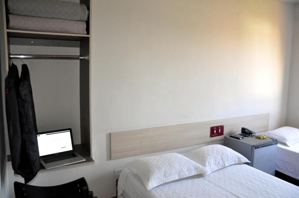 Postel nebo postele na pokoji v ubytování Hotel Caçula