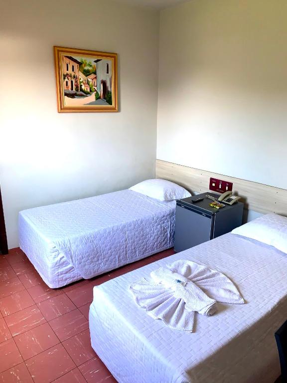 Postel nebo postele na pokoji v ubytování Hotel Caçula