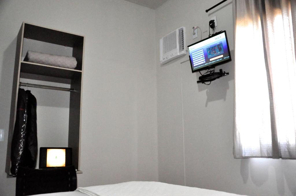 Postel nebo postele na pokoji v ubytování Hotel Caçula