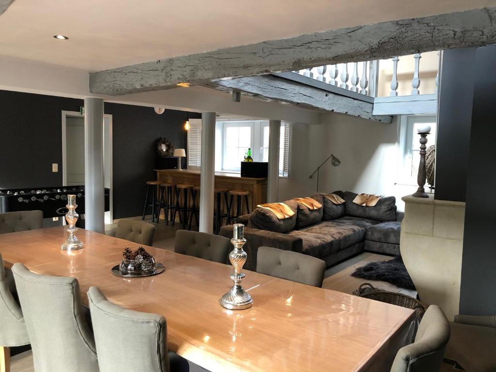 a living room with a table and a couch at le gite des chantoires in Aywaille