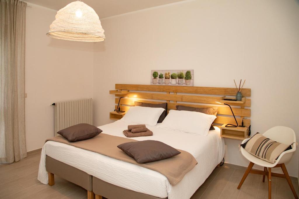 a bedroom with a large bed and a chair at Monferrato Bed&Bike in Murisengo