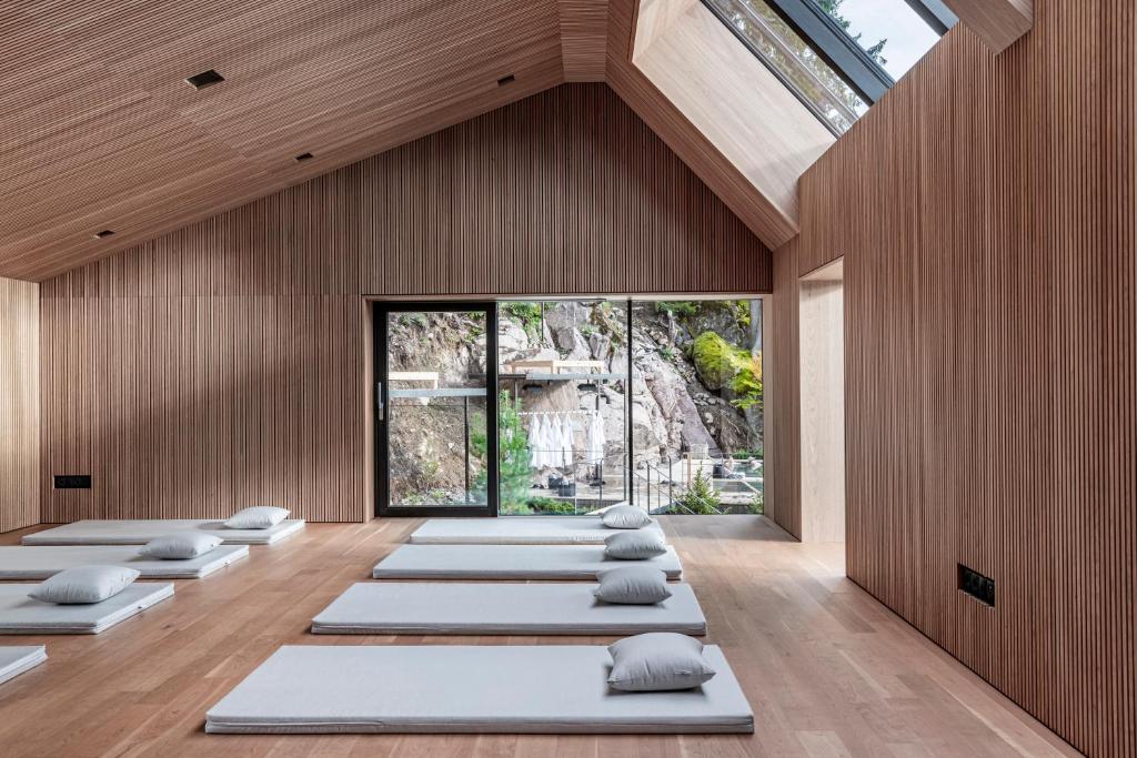 a room with a row of yoga mats on the floor at Miramonti Boutique Hotel in Avelengo