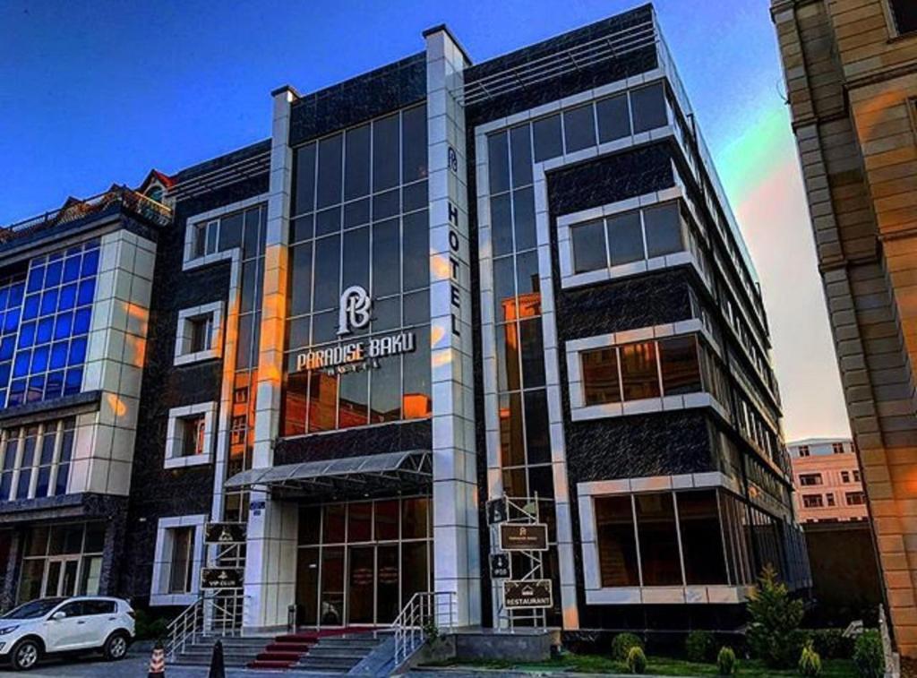 a building with a car parked in front of it at Paradise Hotel Baku in Baku