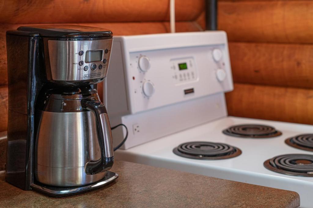 a coffee maker sitting on top of a stove at Cusheon Lake Resort in Ganges