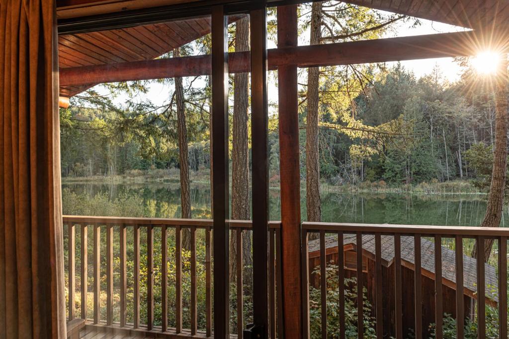 a screened in porch with a view of a lake at Cusheon Lake Resort in Ganges
