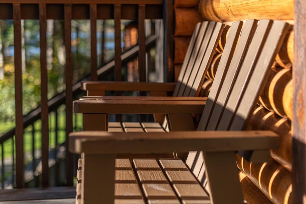 a wooden bench sitting on top of a porch at Cusheon Lake Resort in Ganges
