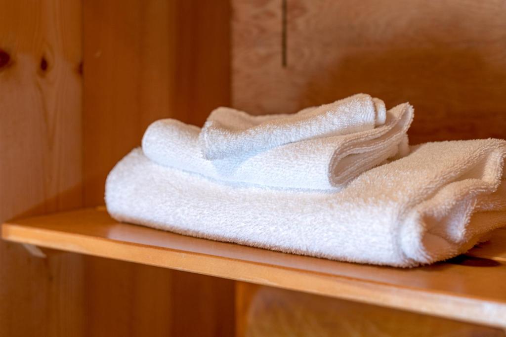 a stack of towels sitting on a shelf at Cusheon Lake Resort in Ganges