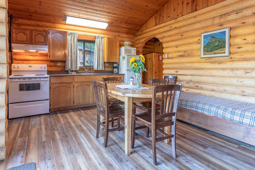 a kitchen with a table and chairs in a cabin at Cusheon Lake Resort in Ganges