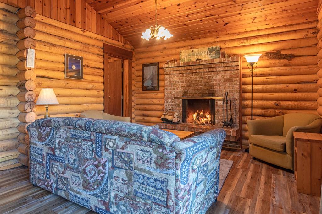 a living room with a couch and a fireplace at Cusheon Lake Resort in Ganges