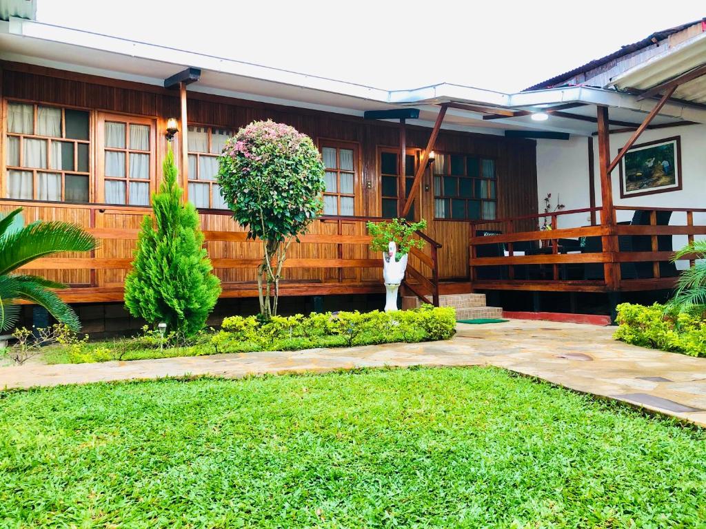 a house with a garden in front of it at CHALET TARAPOTO in Tarapoto