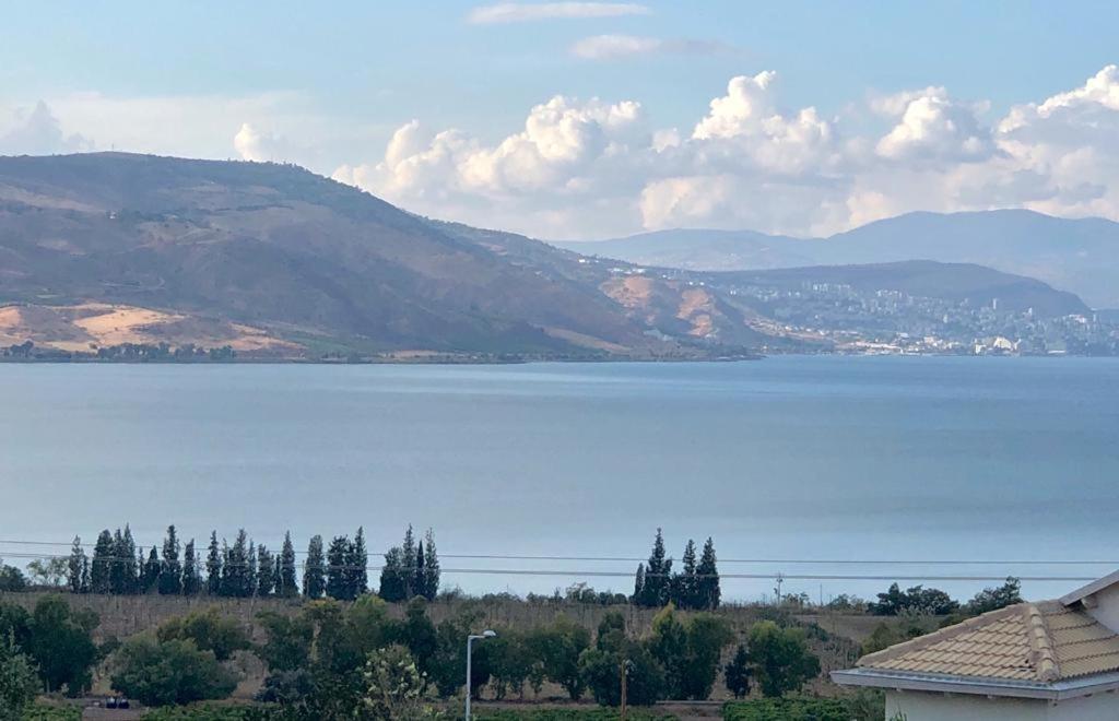 a view of a large body of water with mountains at Me & U My Zimmer In The Kinneret in Tel Kazir